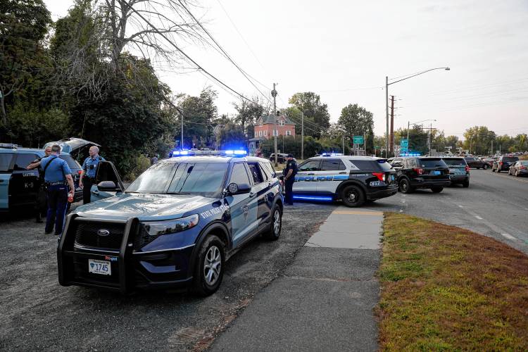 State Police and local law enforcement officers involved in a manhunt for Michael J. Williams, 45, of Greenfield, gather along Route 5 near East Street in Easthampton on Sept. 22.