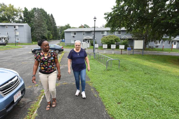 Greenfield Gardens Property Manager Dedra Lewis and Andrea Goldman, president of the Homesavers Council at Greenfield Gardens, walk along Pray Drive in August. Health inspectors are requesting the assistance of the Board of Health as they deal with ongoing concerns from tenants about rodents at Greenfield Gardens.