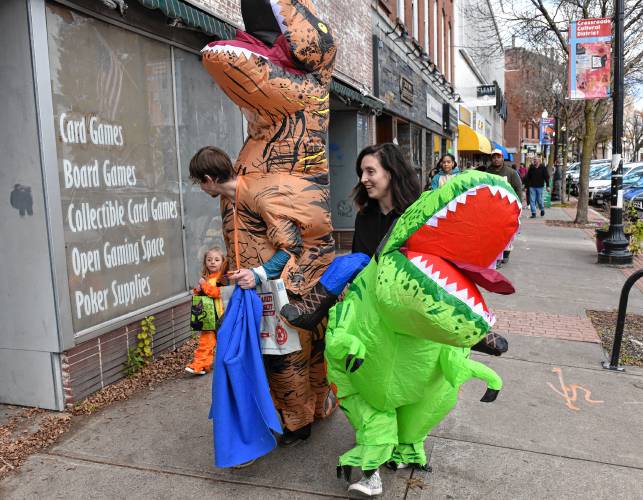 Kids try to keep up with their dinosaurs on Halloween in Greenfield.