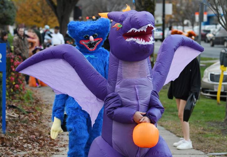 Creatures and dragons walk the streets of Greenfield on Halloween.