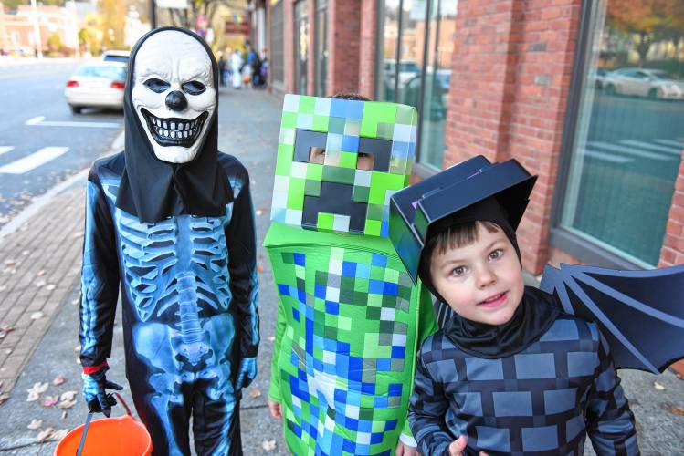 Children collect candy from downtown merchants on Halloween in Greenfield. 