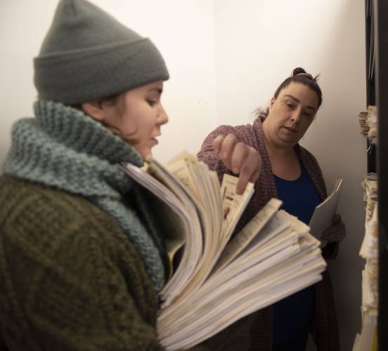 Ashley Drillen, right, an applications and data management coordinator in the fuel assistance department at Community Action Pioneer Valley, trains Sienna Jessurun in processing emergency applications in January. With temperatures beginning to drop, state and local agencies are encouraging eligible residents to apply for fuel assistance through the Low-Income Home Energy Assistance Program.