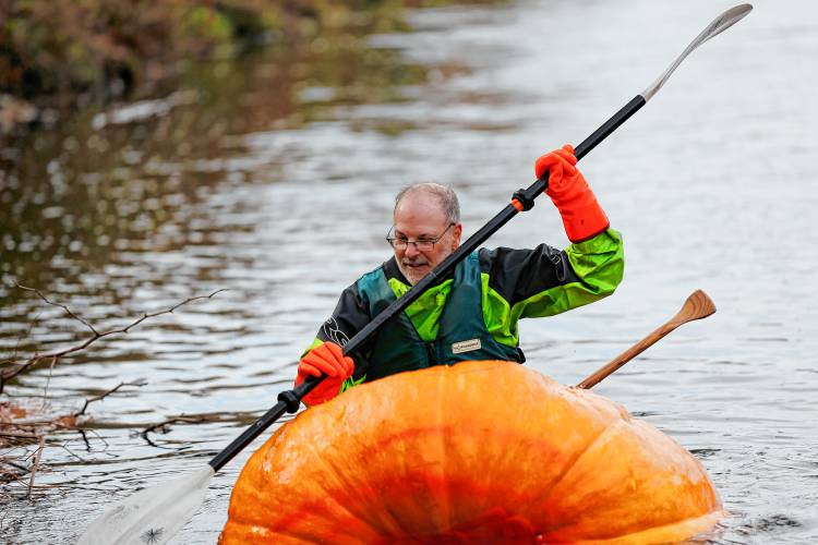 Florence resident Dave Rothstein starts his trek paddling a giant pumpkin down the Deerfield River on Saturday morning en route to the Connecticut River in a world record attempt.