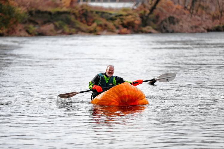 Florence resident Dave Rothstein starts his trek paddling a giant pumpkin down the Deerfield River on Saturday morning en route to the Connecticut River in a world record attempt.