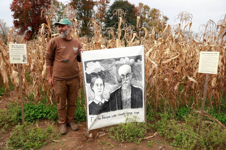 Owner Ryan Voiland stands next to artwork in the popcorn maze at Red Fire Farm in Granby.