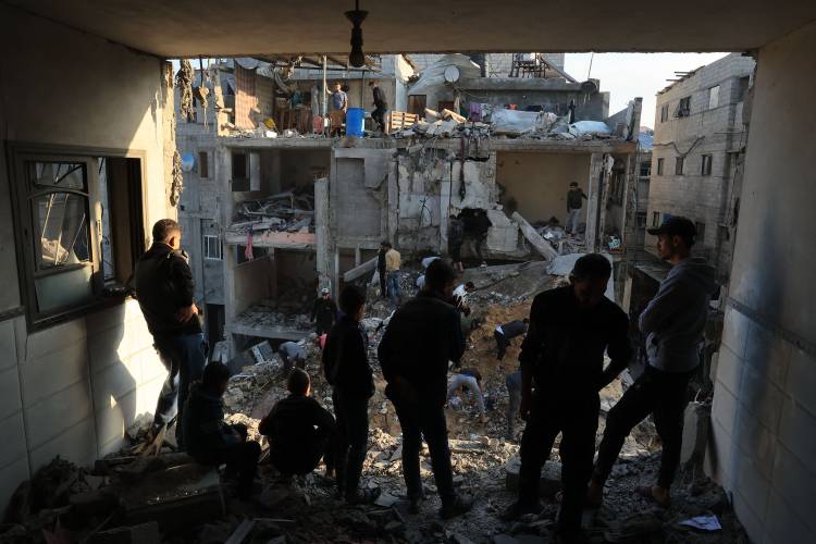 Palestinians inspect the destruction around residential buildings following Israeli air strikes in the Rafah refugee camp in the southern Gaza Strip on Friday, Dec. 1, as fighting resumed shortly after the expiration of a seven-day truce between Israel and Hamas militants.