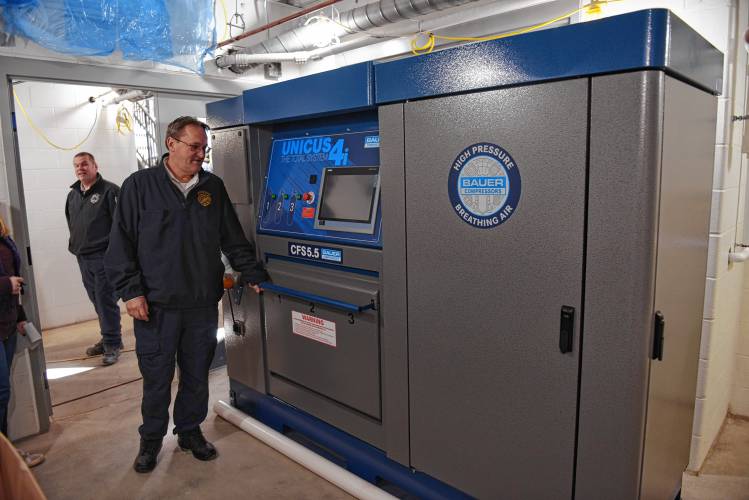 Fire Capt. Peter McIver and Fire Chief Robert Strahan with the air bottle filling machine for Scott Air-Paks.