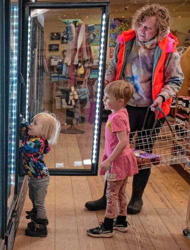 Etta Reagan, 2, Abel Reagan, 4, and their mother, Samantha Spisiak, shop at the Leverett Village Co-Op for after noon snacks on Dec. 19.