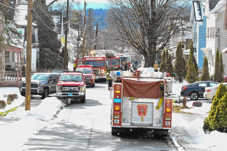 Fire trucks line Mechanic Street in Orange, the scene of a two-alarm fire that displaced a family on Wednesday. 