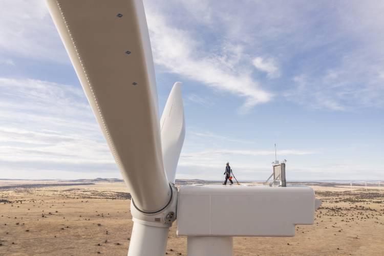 A worker walks atop a wind turbine at the Borderland Wind Project in western New Mexico near the Arizona state line. The BIG WIRES Act would require utilities to more comprehensively tie together various parts of the country’s electrical grid. 