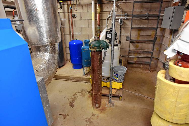 The wellhead for Swift River School in the center of the boiler room.