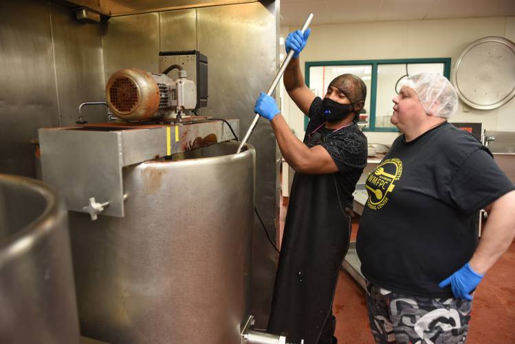 Employee Gigi Gomes and Director of Operations Liz Buxton work on a batch of fudge at the Western Massachusetts Food Processing Center on Wells Street in Greenfield in December 2022. A $155,000 state grant will allow the center to further its work with inmates and formerly incarcerated individuals.