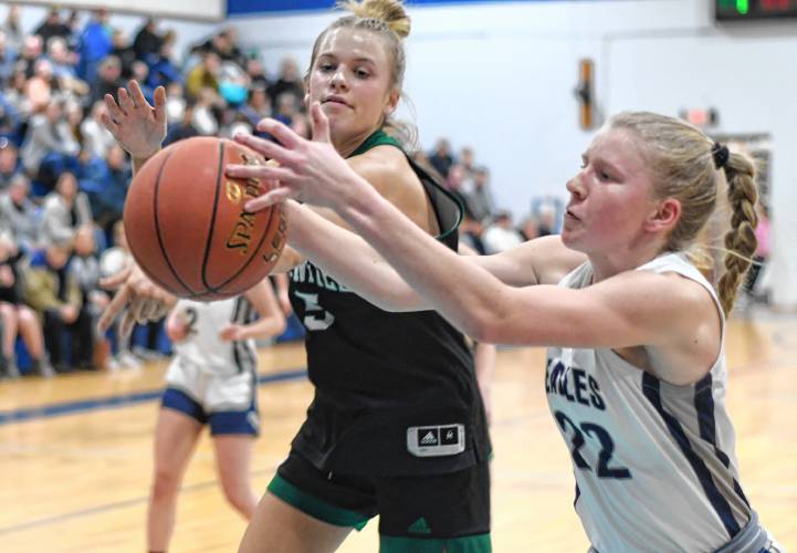 Greenfield’s Gloria McDonald, left, and Franklin Tech’s Kaitlin Trudeau vie for a rebound during the host Eagles’  PVIAC Class C quarterfinal round victory in Turners Falls on Monday night. 