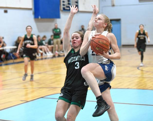 Franklin Tech’s Kaitlin Trudeau goes up for a layup past Greenfield’s Anna Bucala during the host Eagles’  PVIAC Class C quarterfinal round victory in Turners Falls on Monday night. 