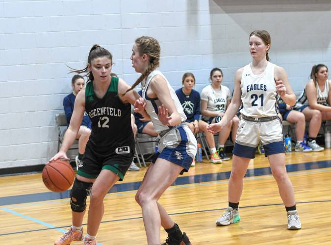 Greenfield’s Amber Bergeron (12) goes to the basket while defended by Franklin Tech’s Lea Chapman during the host Eagles’  PVIAC Class C quarterfinal round victory in Turners Falls on Monday night. 