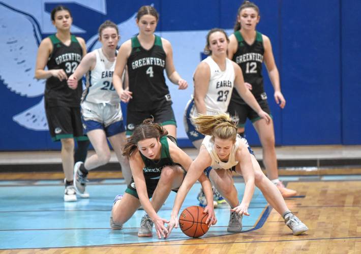 Greenfield’s Tayler Bergeron, left, and Franklin Tech’s Lindsey Taylor dive for a loose ball during the host Eagles’  PVIAC Class C quarterfinal round victory in Turners Falls on Monday night. 