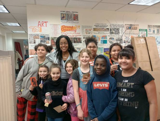 Dr. Khama Ennis, creator of the “Faces of Medicine” documentary series centering on the paths of Black female physicians in the United States, poses for a photo with some young attendees at The LAVA Center in Greenfield on Friday.