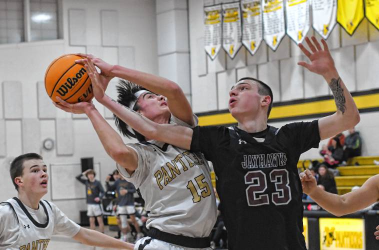 Pioneer’s Alex McClelland is defended by Duggan’s Jason Dulude in first half action of a Western Mass. Class D semifinal contest at Messer Gymnasium in Northfield Wednesday. 