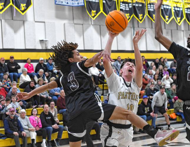 Pioneer’s Brayden Thayer is defended by Duggan’s Allen Miranda in first half action of a Western Mass. Class D semifinal contest at Messer Gymnasium in Northfield Wednesday. 