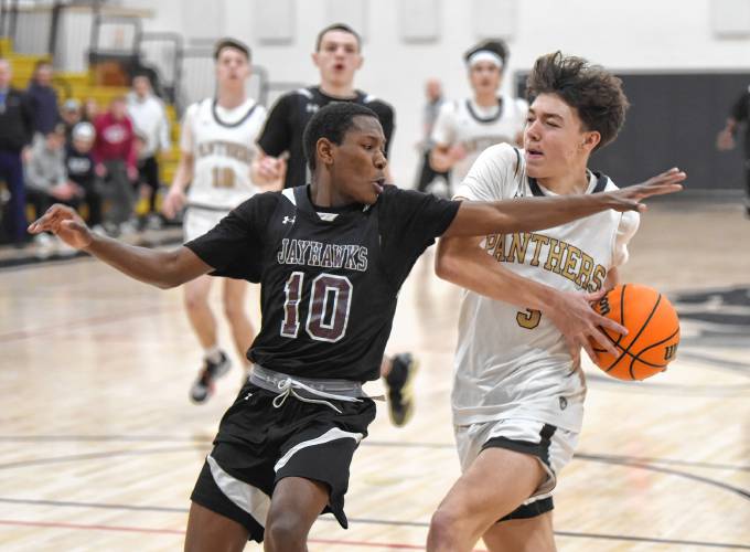 Pioneer’s Kurt Redeker is defended by Duggan’s Daniel Click during a Western Mass. Class D semifinal contest at Messer Gymnasium in Northfield Wednesday. 