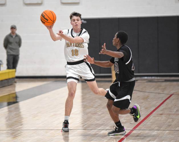 Pioneer’s Brayden Thayer passes the ball past Duggan’s Daniel Click in first half action of a Western Mass. Class D semifinal contest at Messer Gymnasium in Northfield Wednesday. 