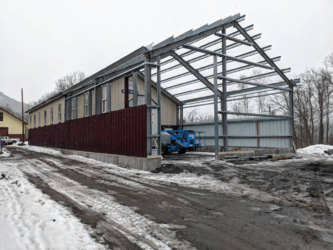 Gagne Mechanical’s crew installs siding panels on the new Car Barn extension at the Shelburne Falls Trolley Museum.