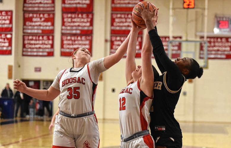 Pioneer’s Fota N’Diaye, right, battles for a rebound with Hoosac Valley’s Taylor Garabedian (35), left, and Emma Meczywor (12), center, during the Panthers’ 57-35 loss in the Western Mass. Class D championship game on Saturday at Westfield High School.