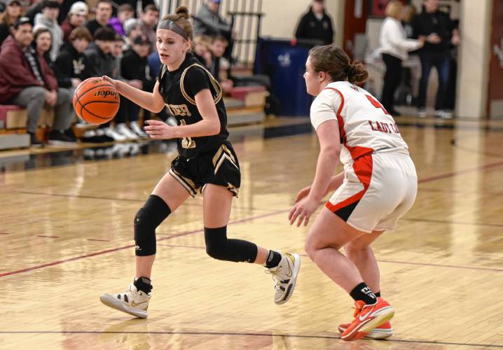 Pioneer’s Kyler McClelland (11), left, dribbles against Hoosac Valley during the Panthers’ 57-35 loss in the Western Mass. Class D championship game on Saturday at Westfield High School.