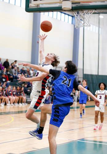 Mahar’s Morgan Softic (2), left, goes up for a breakaway layup defended by Granby’s Gavin Moreno (21) in the second quarter of the Western Mass. Class C boys basketball championship Saturday at Holyoke Community College.