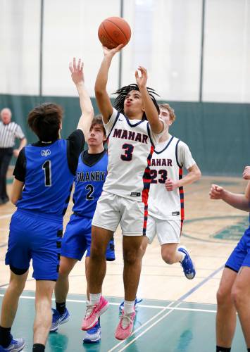 Mahar’s Lian Lopez-Baez (3) puts up a shot in the paint over Granby’s Riley Goodhind (1) in the second quarter of the Western Mass. Class C boys basketball championship Saturday at Holyoke Community College.