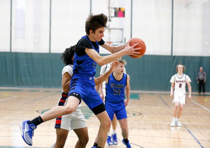 Granby’s Riley Goodhind (1) pulls down a rebound against Mahar in the second quarter of the Western Mass. Class C boys basketball championship Saturday at Holyoke Community College.