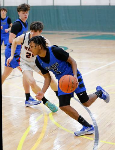 Granby’s Gavier Fernandez (5) drives the ball against Mahar in the third quarter of the Western Mass. Class C boys basketball championship Saturday at Holyoke Community College.