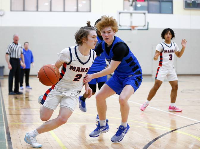 Mahar’s Morgan Softic (2) drives the ball past Granby’s Colin Murdock (4) in the fourth quarter of the Western Mass. Class C boys basketball championship Saturday at Holyoke Community College.