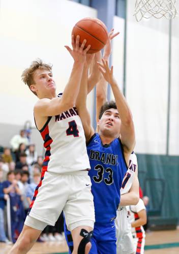 Mahar’s Lucas Isrow (4) pulls down a rebound over Granby’s Ben Berger (33) in the fourth quarter of the Western Mass. Class C boys basketball championship Saturday at Holyoke Community College.