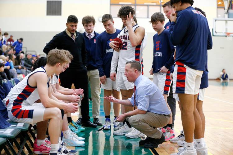 Mahar head coach Chad Softic huddles up with his team in the fourth quarter against Granby during the Western Mass. Class C boys basketball championship Saturday at Holyoke Community College.