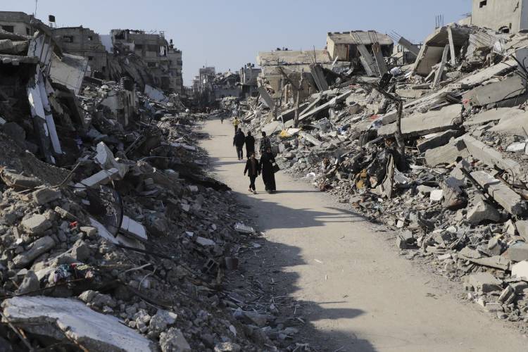 Palestinians walk through the destruction from the Israeli offensive in Jabaliya refugee camp in the Gaza Strip on Feb. 29.