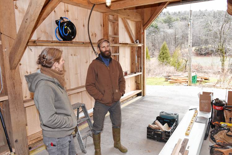 Co-owners Maggie Toran and David Fisher in the vegetable washing and packing area that they have updated at Natural Roots farm in Conway.