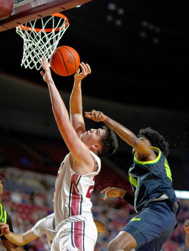 UMass forward Josh Cohen (23) drives to the hoop before being fouled by South Florida’s Gerald Jones (21) in the first half earlier this season at the Mullins Center in Amherst.