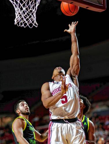 UMass guard Keon Thompson (5) puts in a breakaway layup against South Florida in the second half Saturday at the Mullins Center in Amherst.