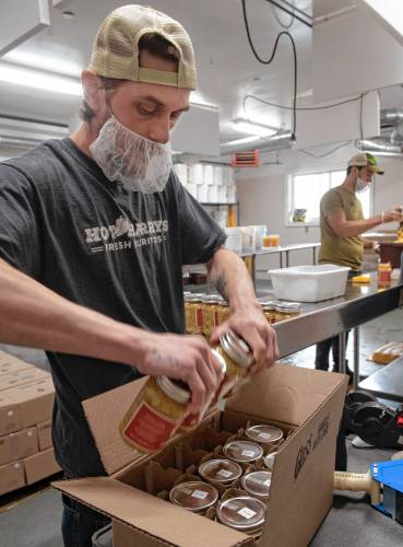 Damien Vieu packages kimchi at Real Pickles in Greenfield.