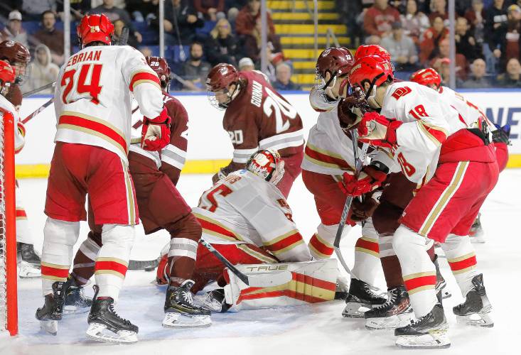 UMass forward Liam Gorman (20) knocks in a shot past Denver goalie Matt Davis to score in the second period of the opening round of the NCAA tournament Friday at the MassMutual Center in Springfield.