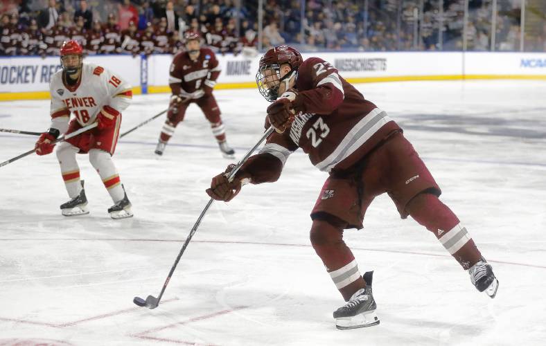 UMass defender Scott Morrow (23) fires a shot against Denver during double overtime of the opening round of the NCAA tournament Friday at the MassMutual Center in Springfield.