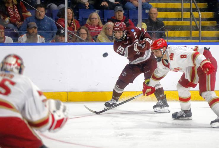 UMass defender Aaron Bohlinger (25) fires a shot against Denver during double overtime of the opening round of the NCAA tournament Friday at the MassMutual Center in Springfield.