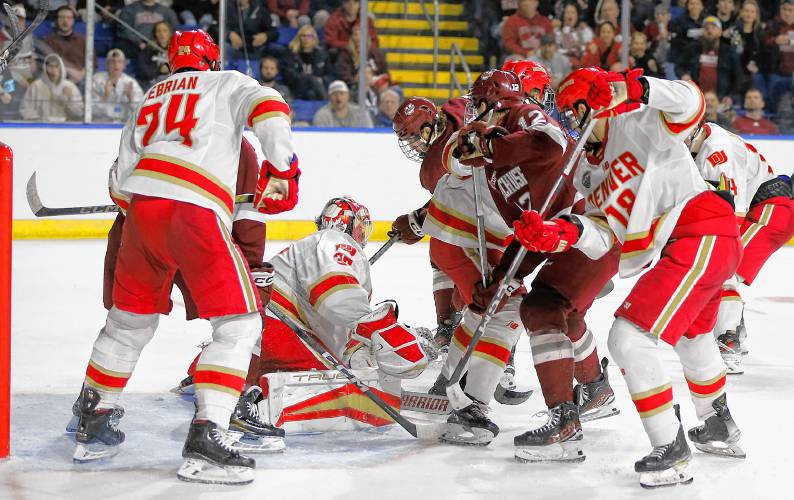 UMass forward Liam Gorman (20) knocks in a shot past Denver goalie Matt Davis to score in the second period of the opening round of the NCAA tournament Friday at the MassMutual Center in Springfield.