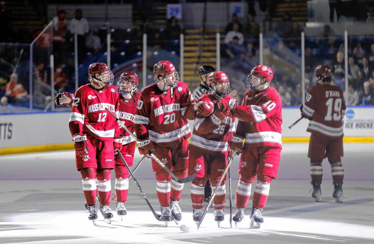 UMass players celebrate after a goal by Liam Gorman (20) against Denver in the second period of the opening round of the NCAA tournament Friday at the MassMutual Center in Springfield.