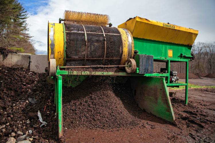 Compost debris gets sifted through a screening machine on Saturday morning at Bear Path Compost in Whately.