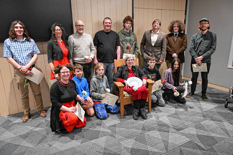 Joannah Whitney, the winner in the adult category, sits in the Poet’s Seat surrounded by the other finalists at the Poet’s Seat Poetry Contest awards ceremony at the Greenfield Public Library on Tuesday evening.