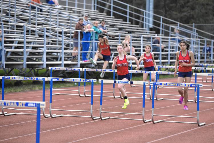 Frontier athletes compete in the 100 hurdles during a meet against Mohawk Trail on Monday in Buckland. 