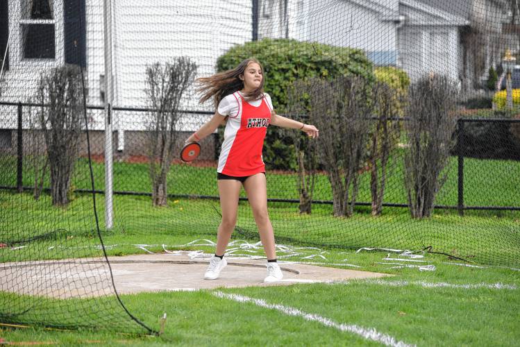 Athol’s Emi Lopez competes in the discus during a meet in Greenfield on Wednesday. 