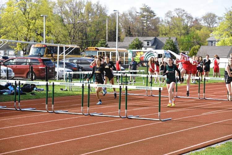 Athletes from Greenfield, Pioneer and Athol compete in the girls 100 hurdles during a meet in Greenfield on Wednesday. 